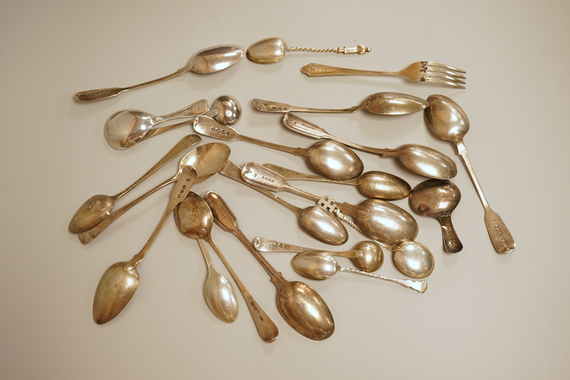 A small quantity of 18th century and later assorted silver teaspoons, various patterns, dates and makers, together with a George V silver pastry fork and two George V silver caddy spoons, 10.7oz.